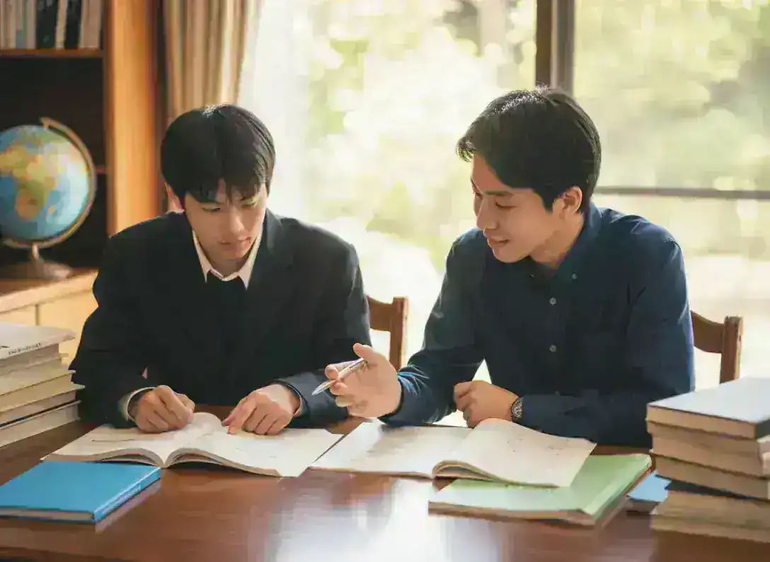 S-Projectの指導風景 - 講師が生徒に寄り添い、一緒に問題を解きながら理解を深めている様子